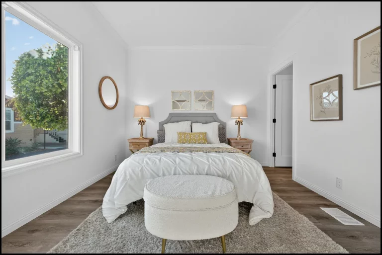 a bedroom with a bed and a round ottoman