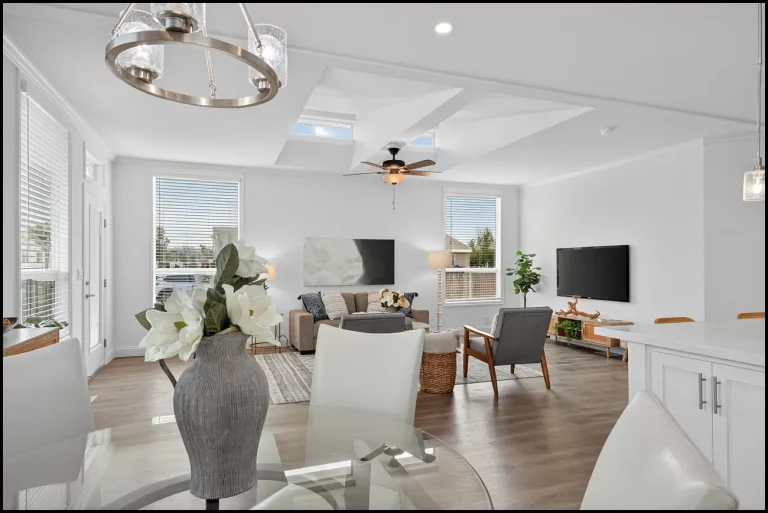 a living room with a tv and a vase of flowers