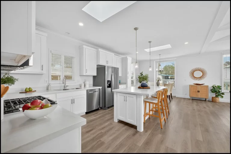 a kitchen with white cabinets and a table