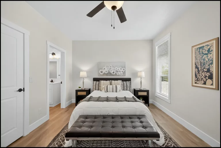 a room with a bed and a fan