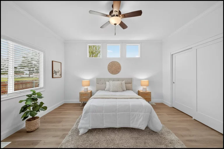 a bedroom with a bed and a ceiling fan