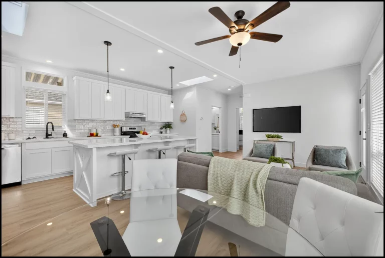 a living room with a kitchen and dining area