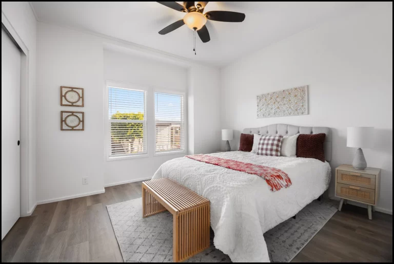 a bedroom with a bed and a bench