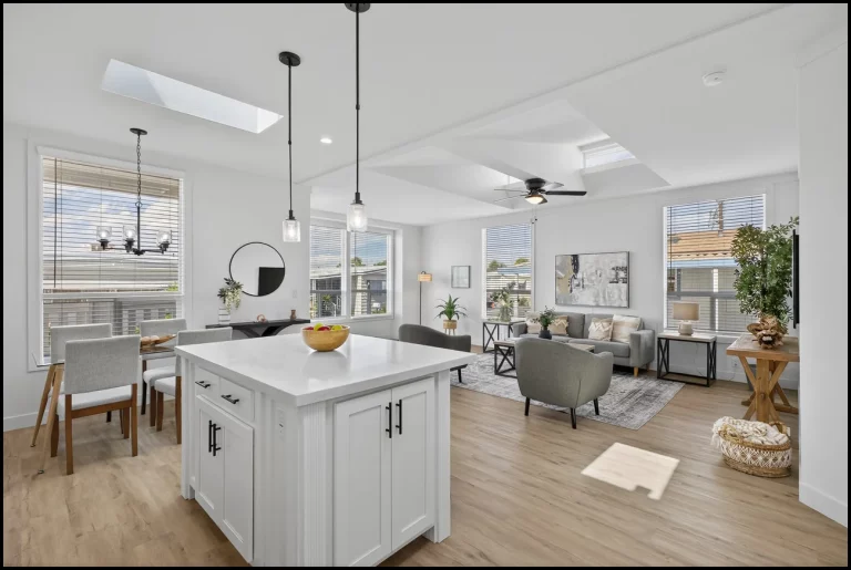 a kitchen and living room with a large ceiling fan