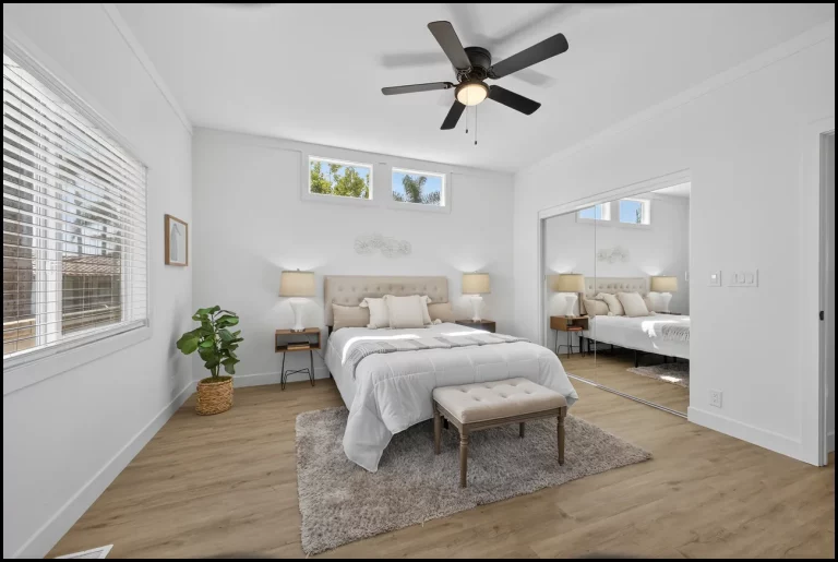 a bedroom with a bed and a fan