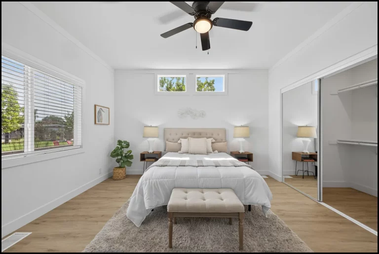 a bedroom with a bed and a fan