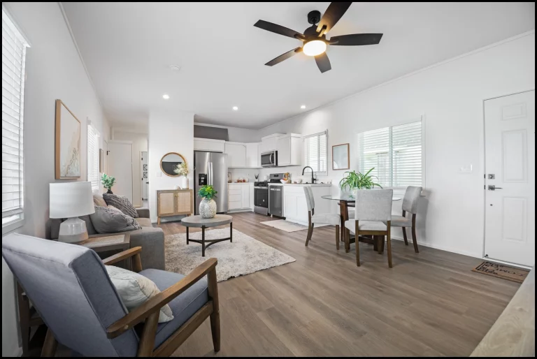 a living room with a kitchen and dining area