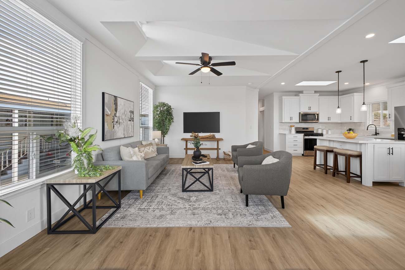 Open-plan living room with television, dining area, and kitchen