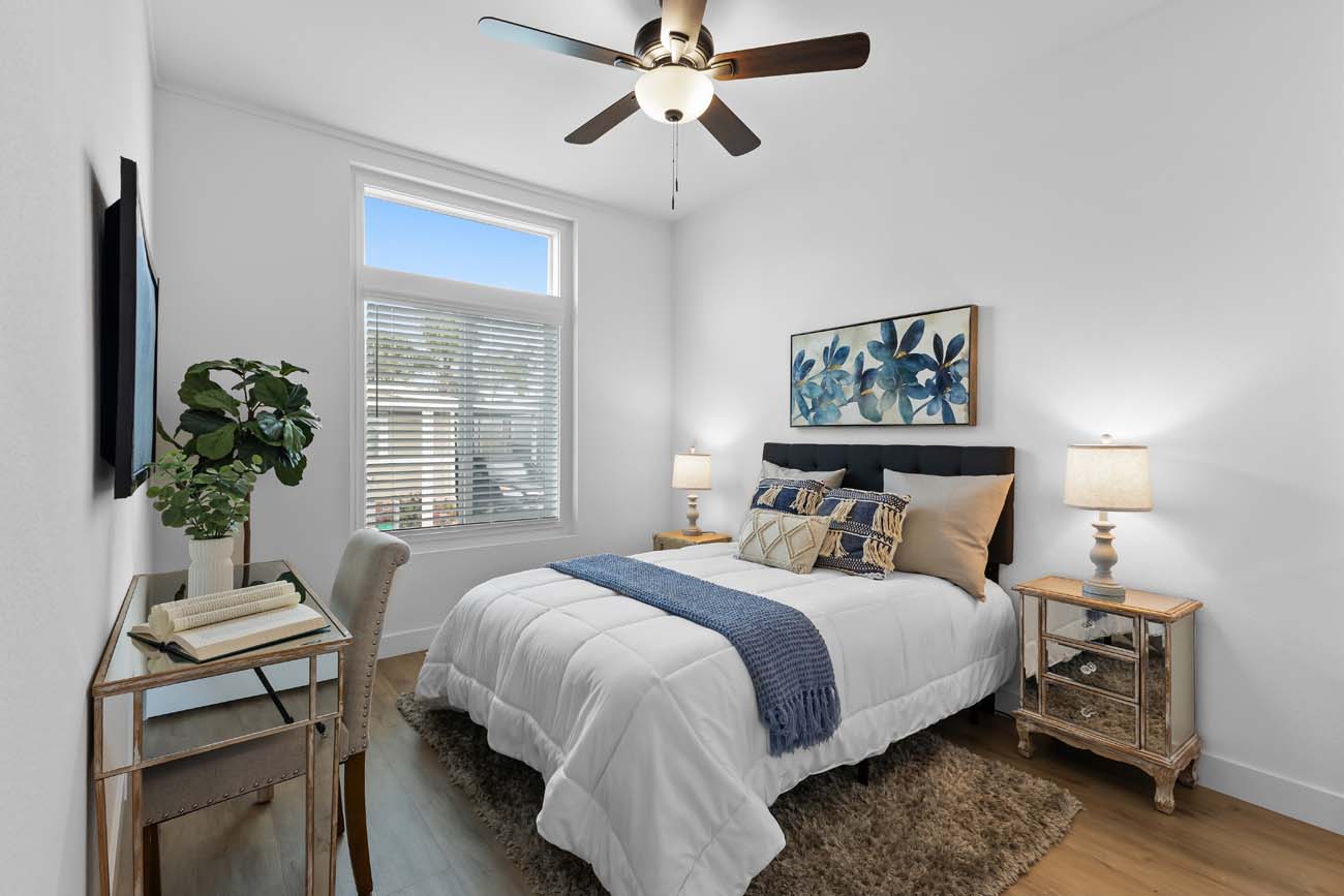 166th Street bedroom with blue accents and natural wood nightstands