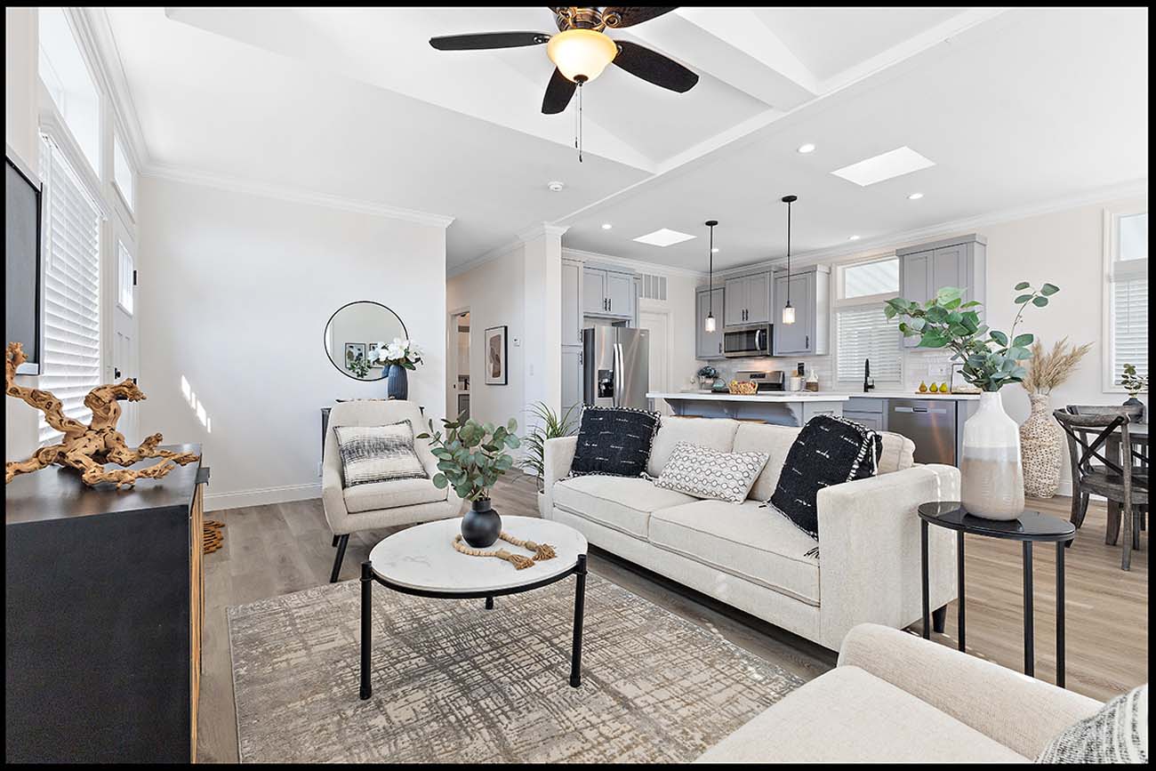 Beach Boulevard open-concept living room with white sofa and kitchen beyond