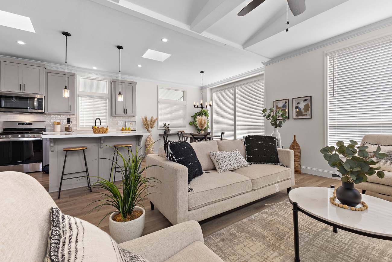 Beach Boulevard living room with white sofa, island kitchen, and skylights