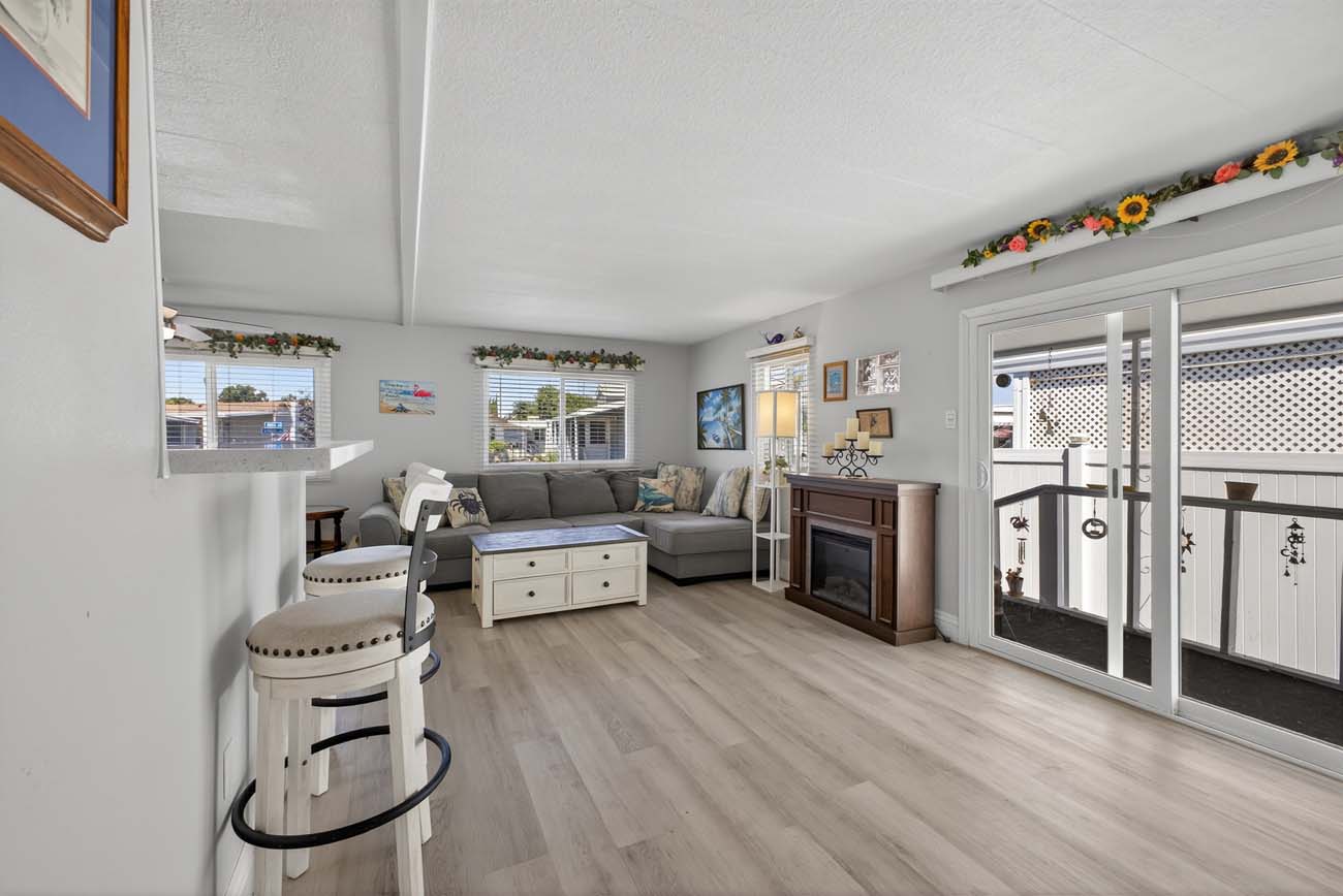 Bright living area with breakfast bar, fireplace, and sliding glass doors