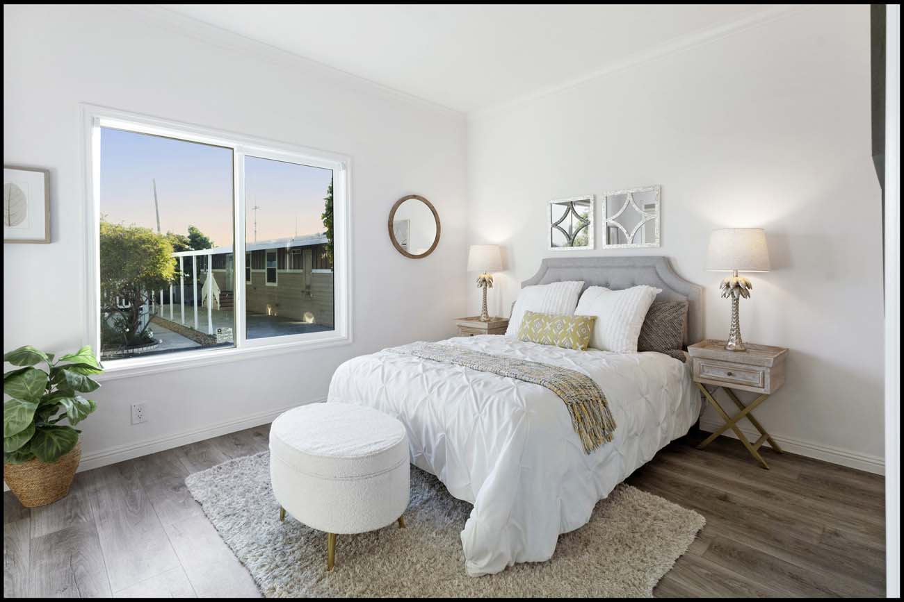 Normandie Avenue bedroom with a large window and neutral staging